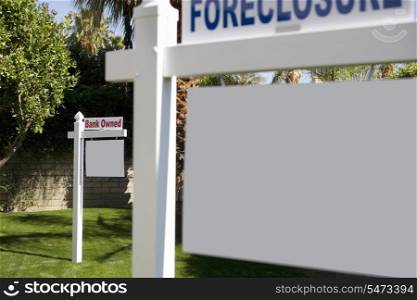 Foreclosure and Bank Owned signs in lawn