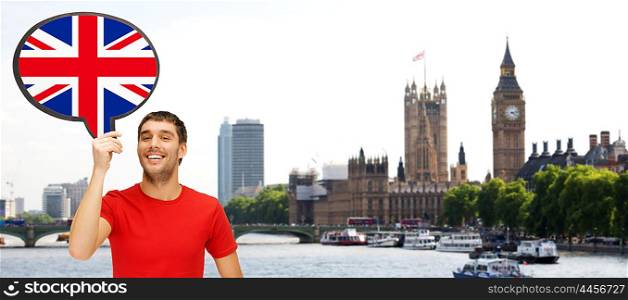 foreign language, english, travel, people and communication concept - smiling young man holding text bubble of british flag over london city and big ben tower background