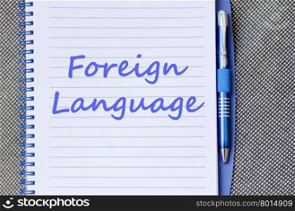 Foreign language text concept write on notebook with pen