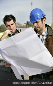 Foreman and colleague checking over plans