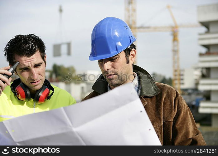 Foreman and colleagues examining building plans