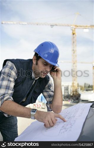 Foreman checking plan