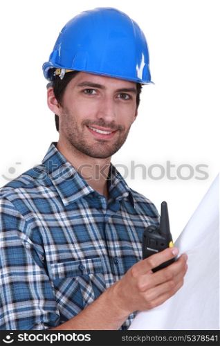 Foreman holding radio and plans