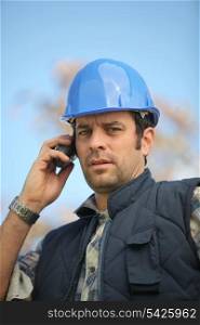 foreman in construction site making a call
