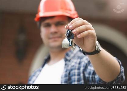Foreman in hardhat giving keys of new house