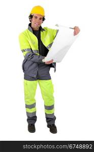 Foreman in reflective work-wear examining plans