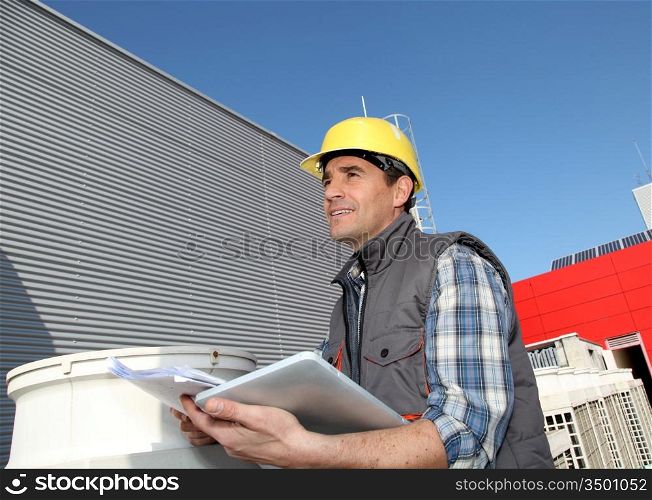 Foreman on industrial site with tablet