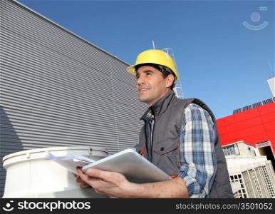 Foreman on industrial site with tablet