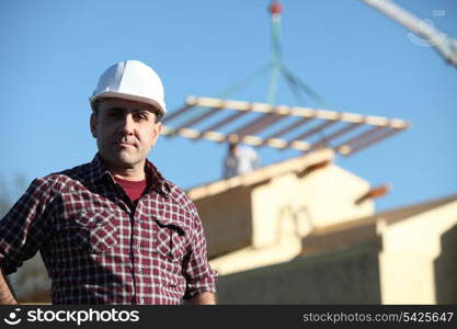 Foreman overseeing construction of house