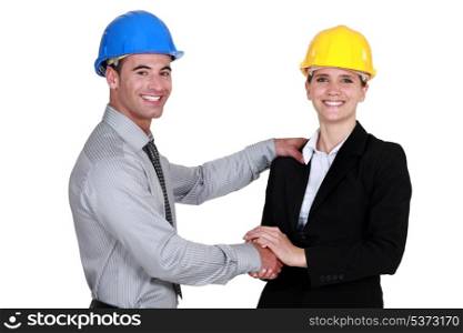 foreman shaking hands with female architect