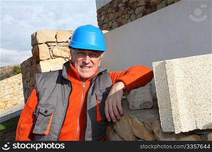 Foreman standing in front of house under construction
