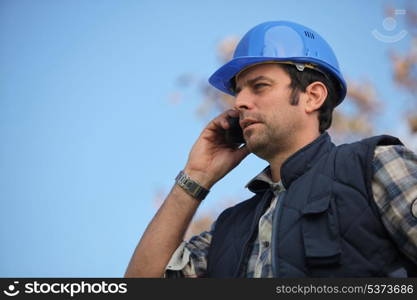 Foreman talking on his mobile phone