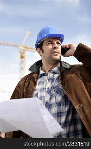 Foreman using a mobile telephone