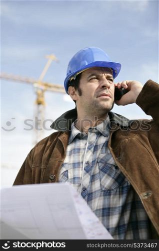 Foreman with a laptop and phone