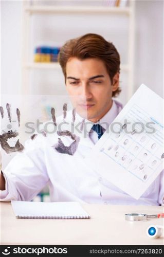 Forensic expert studying fingerprints in the lab. The forensic expert studying fingerprints in the lab