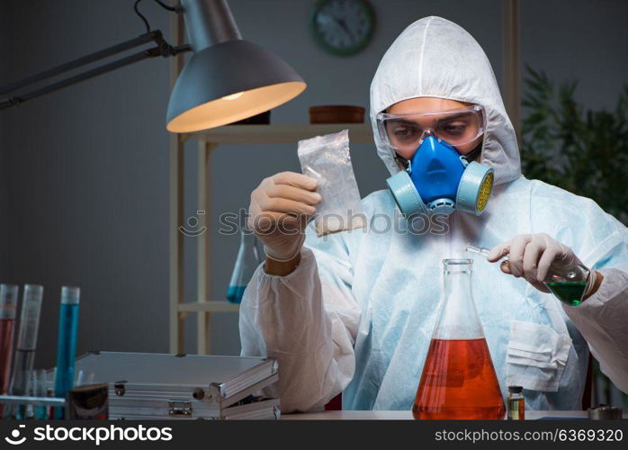 Forensic investigator working in lab looking for evidence