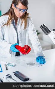 Forensic science expert examining objects from a crime scene