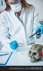 Forensic scientist examining human skull