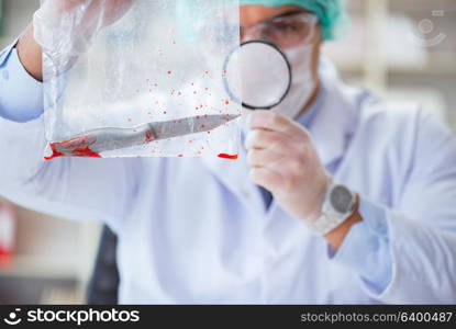 Forensics investigator working in lab on crime evidence