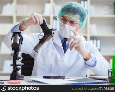 Forensics investigator working in lab on crime evidence. The forensics investigator working in lab on crime evidence