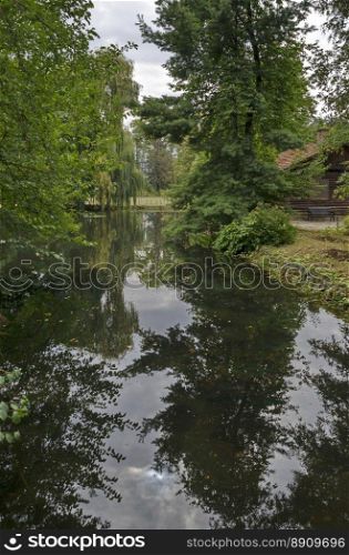 Forest and lake with reflection in National monument of landscape architecture Park museum Vrana in former time royal palace on the outskirts of Sofia, Bulgaria, Europe 