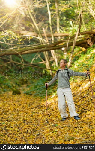 Forest bathing on a beautiful autumn day. Mindful, spiritually awaken woman practicing forest bathing technique on a beautiful autumn day. Forest bathing on a beautiful autumn day