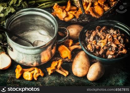 Forest mushrooms , ingredients and cooking pot, preparation on dark kitchen table