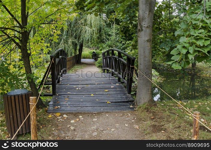 Forest, path and bridge in National monument of landscape architecture Park museum Vrana in former time royal palace on the outskirts of Sofia, Bulgaria, Europe 