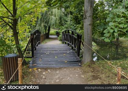 Forest, path and bridge in National monument of landscape architecture Park museum Vrana in former time royal palace on the outskirts of Sofia, Bulgaria, Europe 