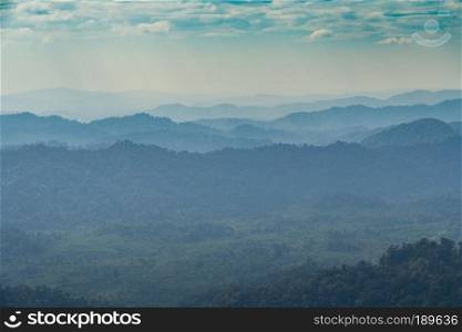 Forests and mountains. Mountain complex arrangement. The sky is in the rainy season.