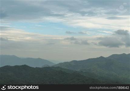 Forests and mountains. Mountain complex arrangement. The sky is in the rainy season.