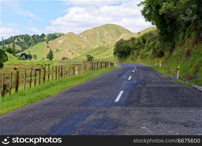 Forgotten World Highway in Taranaki, New Zealand. Lonely scenic highway through farmland in Taranaki, New Zealand