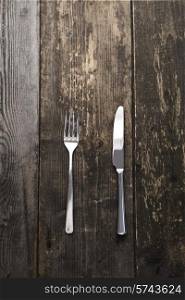 fork and knife on a dark wooden background
