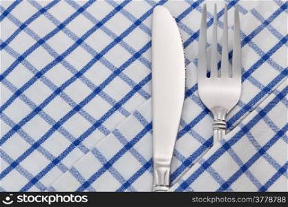 Fork and knife on napkin for dining table background