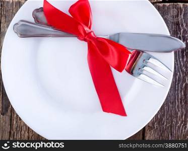 fork and knife on plate and on a table