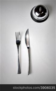 fork and knife on table with restaurant ring