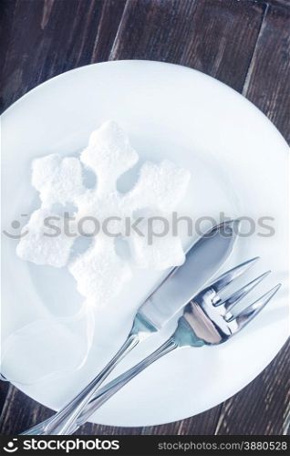 fork and knife on white plate and on a table