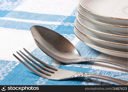 fork and spoon stack of plates on the table