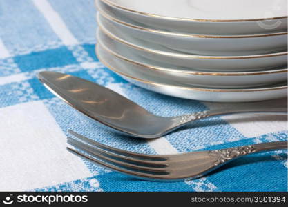 fork and spoon stack of plates on the table