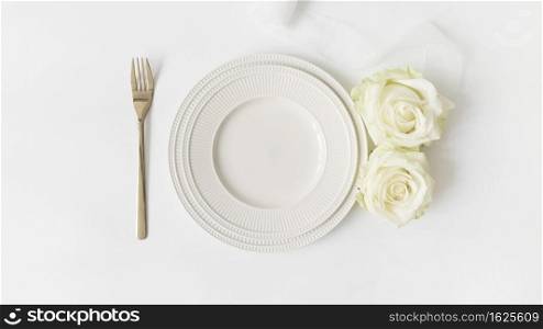 fork ceramic plate roses satin ribbon white background