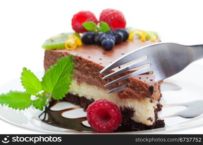 Fork cutting into a double decker chocolate cheese cake, Focus on fork shallow depth of field