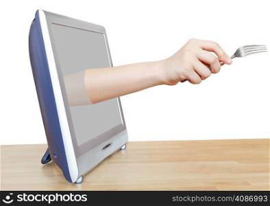 fork in female hand leans out TV screen isolated on white background