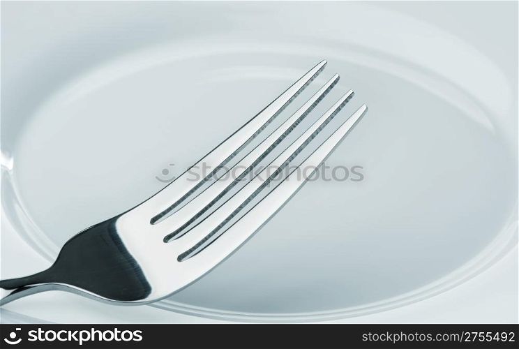 fork on a plate. Kitchen accessories close up