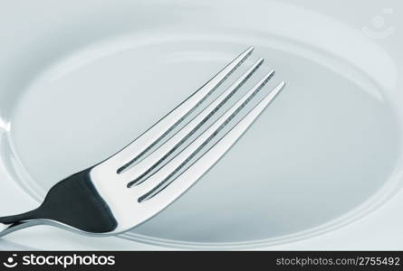 fork on a plate. Kitchen accessories close up