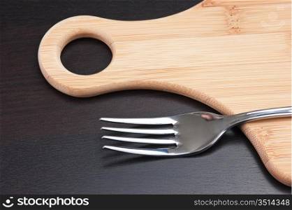 fork on a wooden cutting board