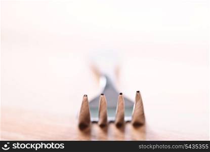 Fork on wooden table. Close up, selective focus. Shallow deep of field