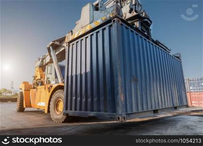 forklift handling container box loading from dock to truck