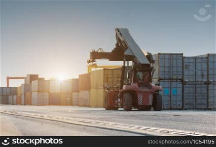 Forklift handling no container box loading at sunset