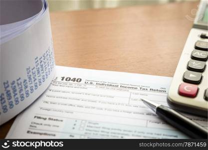 Form 1040, U.S. Individual income tax return, place on table with printed paper roll