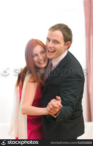 Formally dressed happy couple having fun dancing